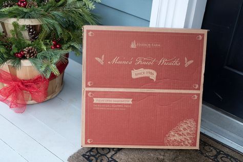 Harbor Farm's Signature Red Wreath Box Sitting on a Porch.