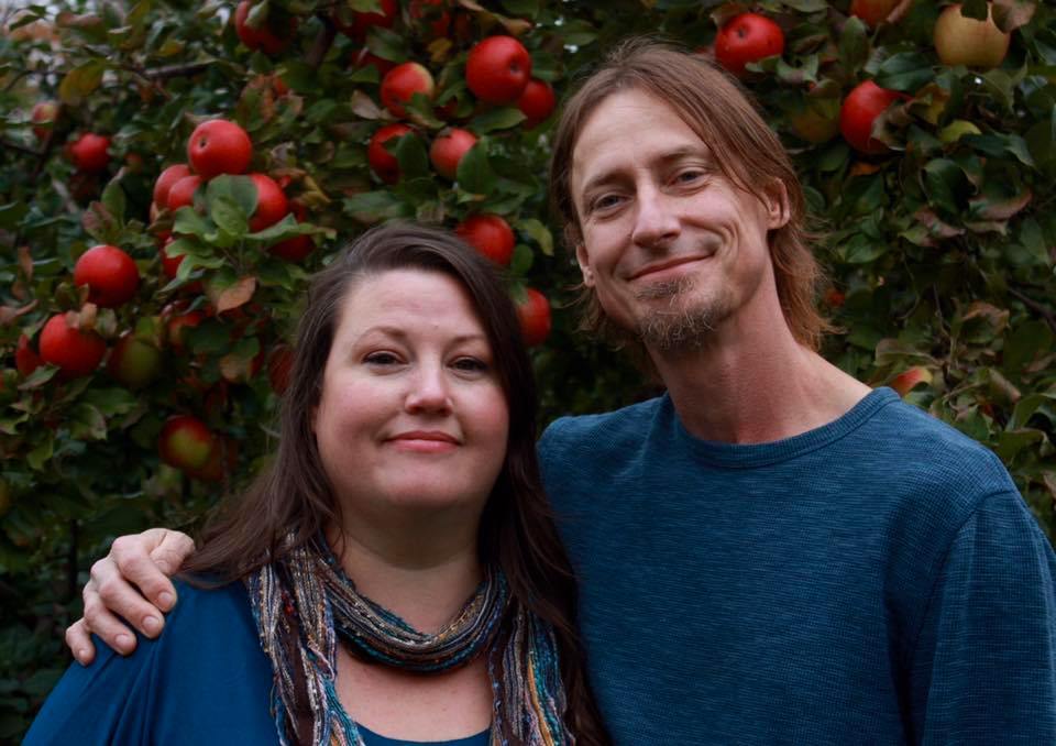 Owners, Mandi and Michael Leman, posing together in a local apple orchard in Maine